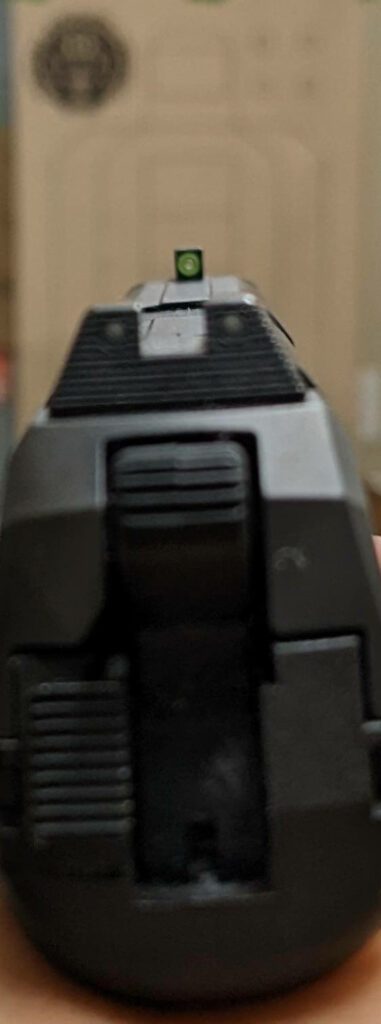 pistol iron sights pointed at a blurry target