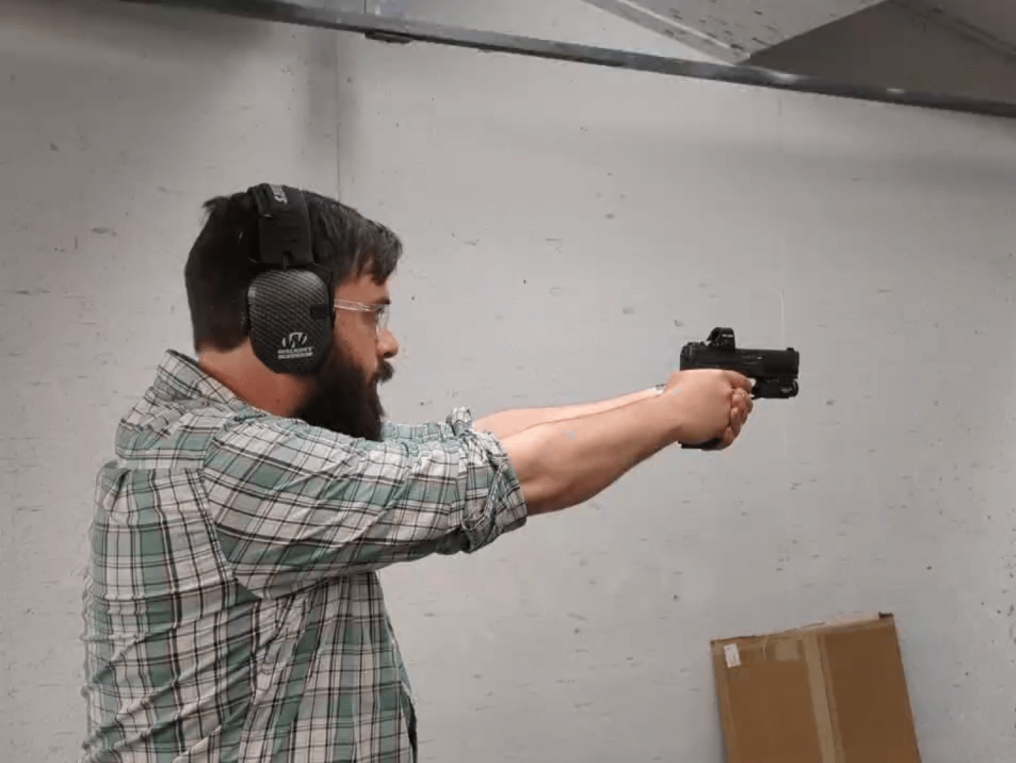 Man pointing a gun at a target