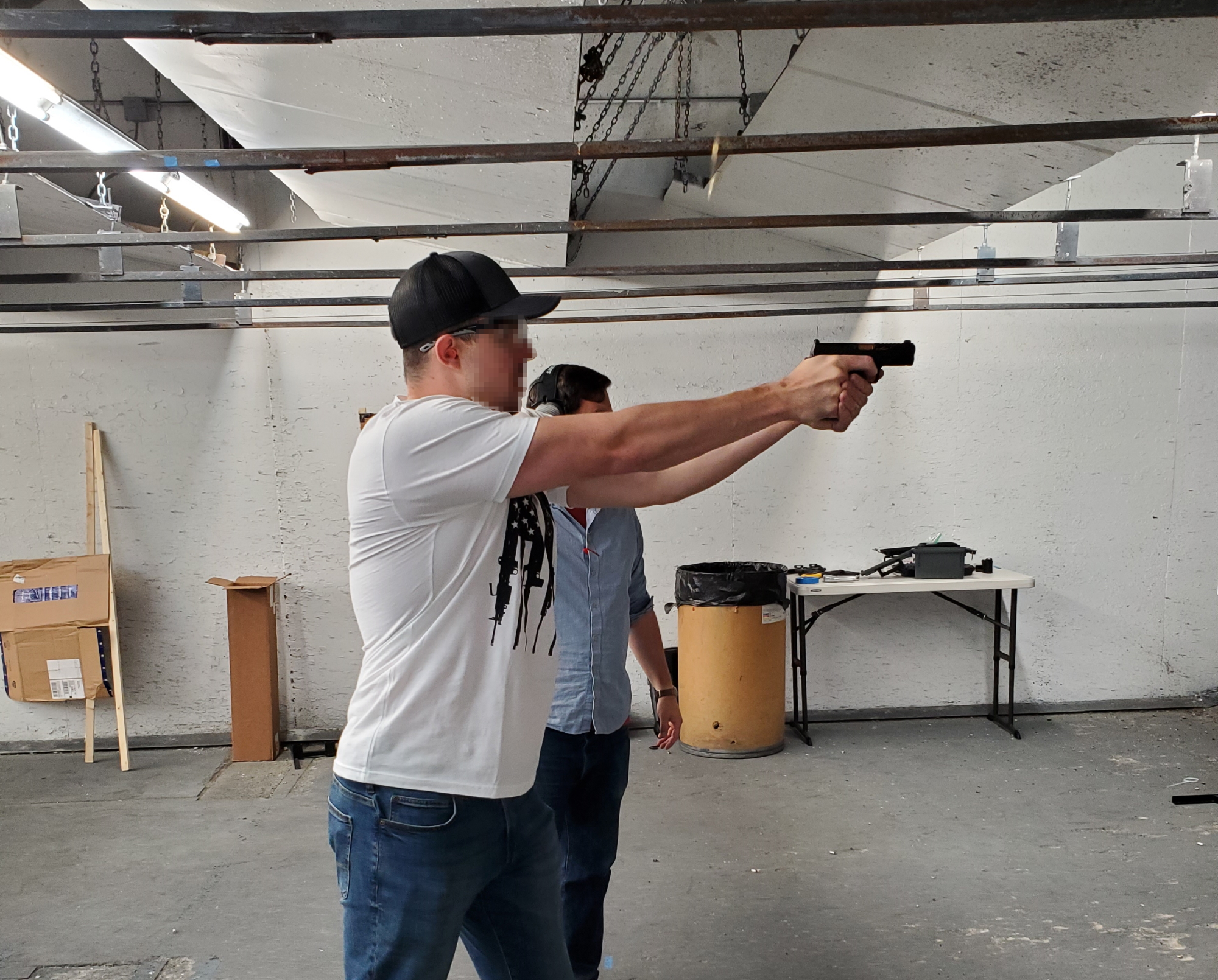 man firing a pistol in training